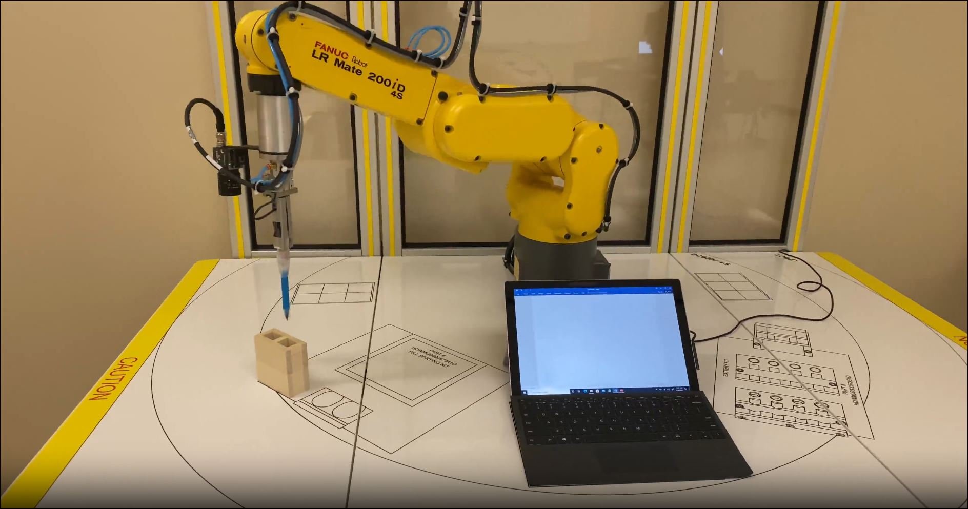 Advanced Manufacturing yellow robot with laptop computer